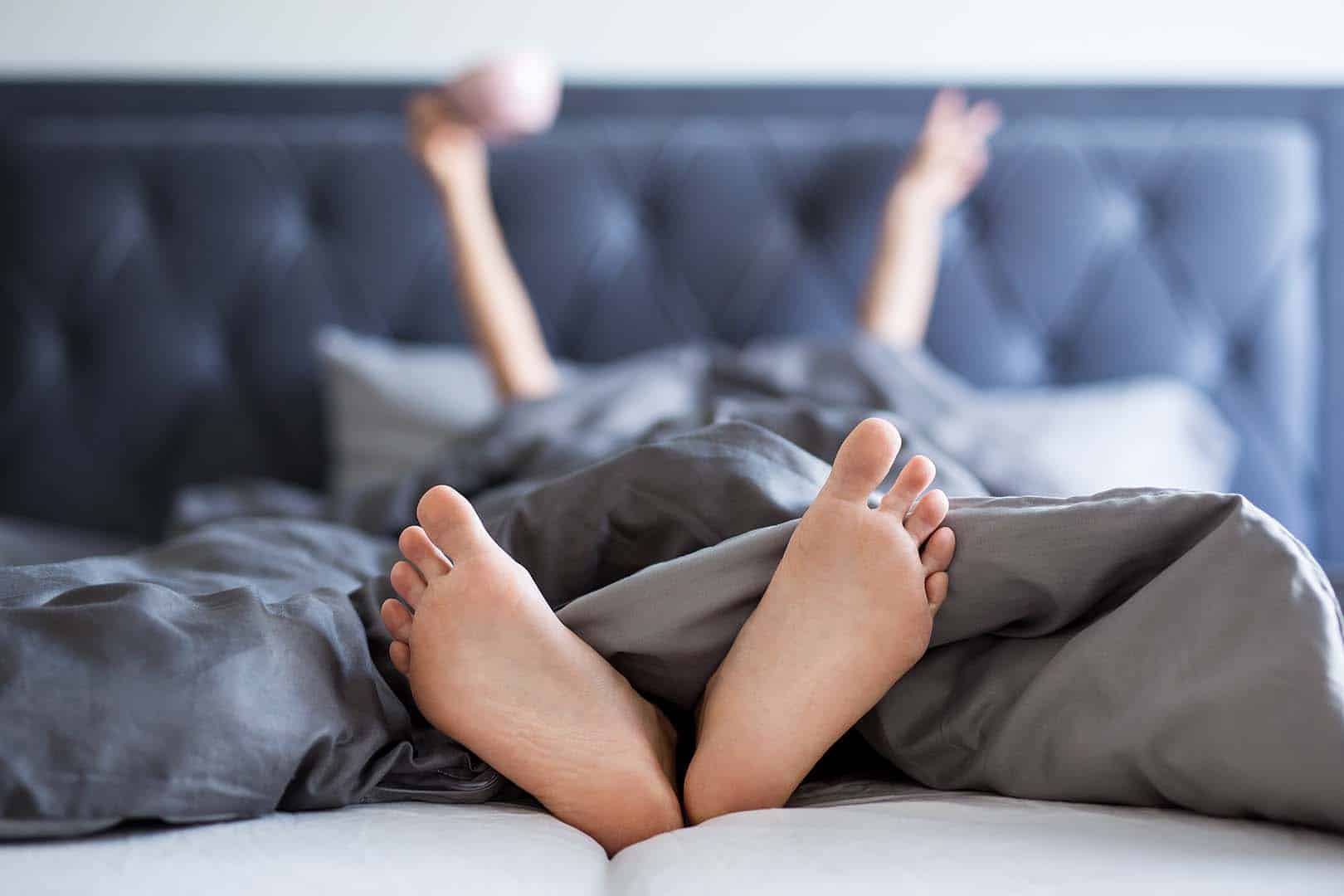 feet in bed sleep tourism