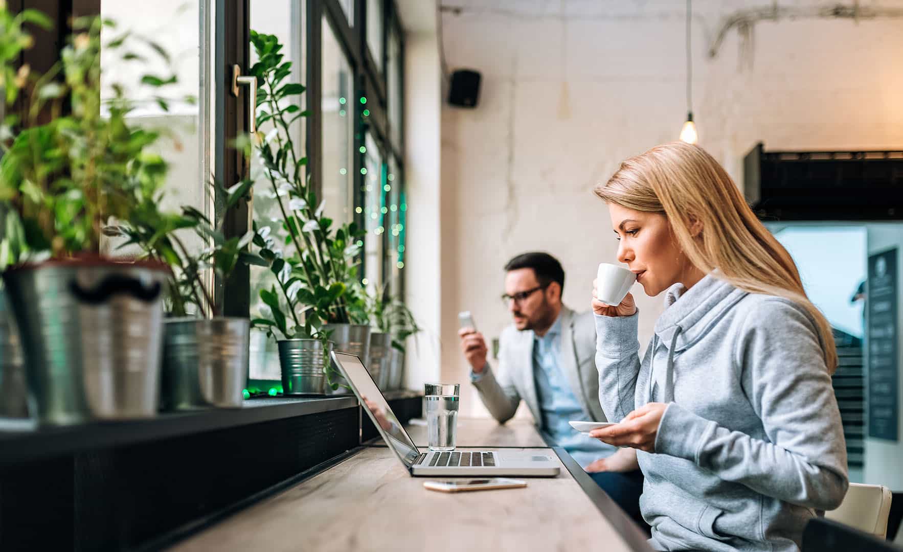 young woman remote work cafe