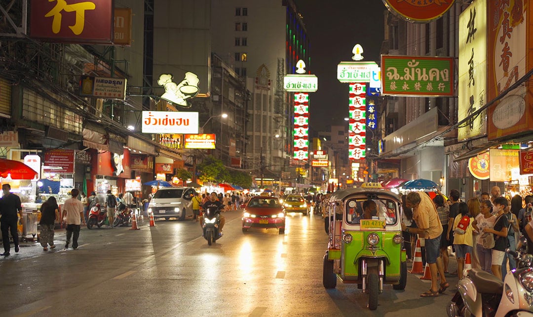 Night market at Yaowarat road, Bangkok City, Thailand. The famous tourist attraction with full of advertising Chinese signs. Cars of tourists people with billboard. China town. Walking street. bangkok at night