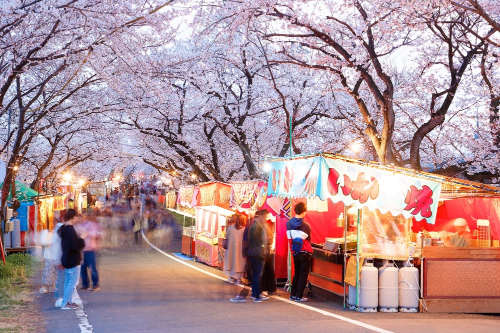Tourists,Stroll,In,A,Temporary,Street,Market,And,Stop,By japan night market